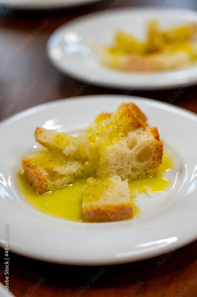 Tasting of Italian extra virgin olive oil with bread on organic farm in Tuscany, Italy Tasting of Italian extra virgin olive oil with bread on organic farm in Tuscany, Italy
