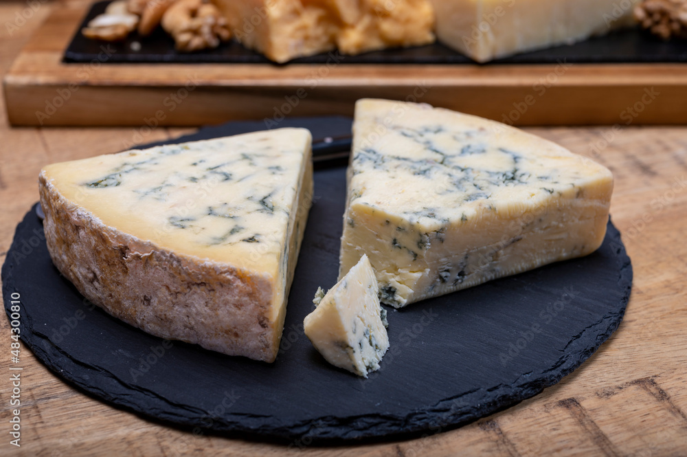 British cheeses collection, blue Stilton, Scottish coloured and English matured cheddar cheeses