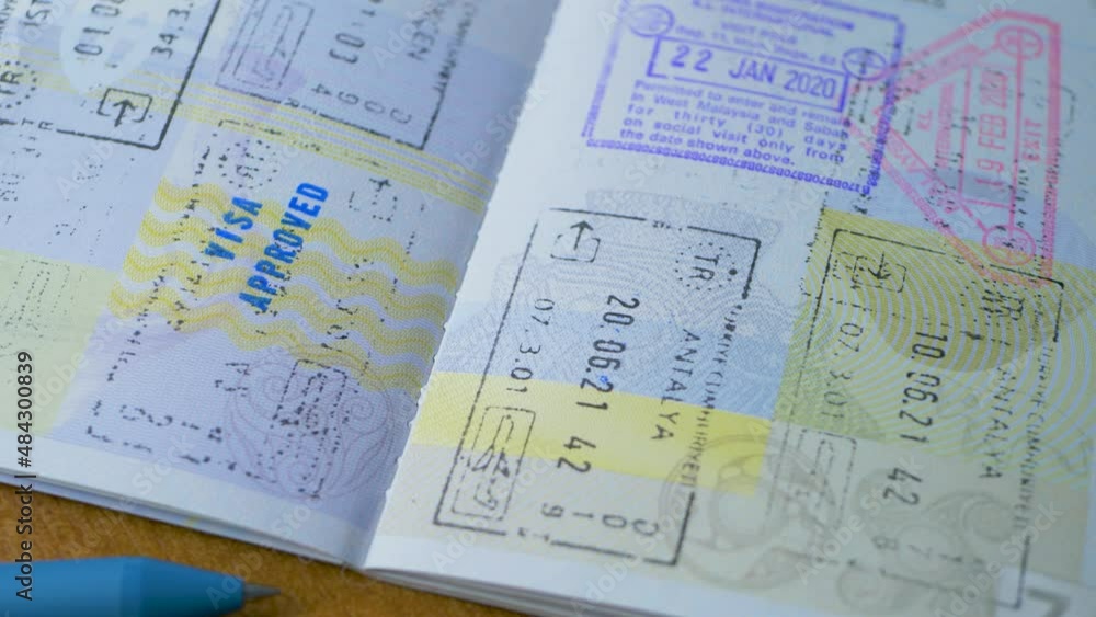 ANTALYA, TURKEY - CIRCA JANUARY, 2022: Visa stamp in passport ID. Entry in foreign country. Malaysia, Turkey, Antalya, Istanbul ANTALYA, TURKEY - CIRCA JANUARY, 2022: Visa stamp in passport ID. Entry in foreign country. Malaysia, Turkey, Antalya, Istanbul