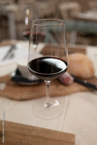 Dinner with glass of dry red wine in traditional Italian osteria restaurant