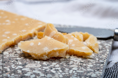 72 months very old Italian parmigiano-reggiano parmesan cheese from Parma has amber color, dry, extremely grainy and crumbly with very intense taste.