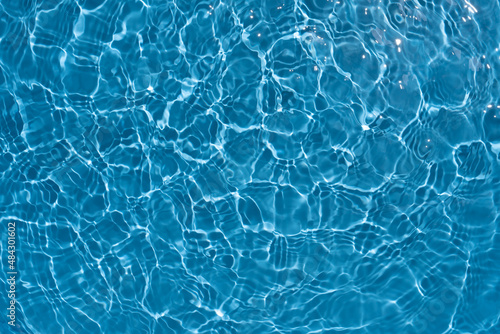 Shining blue water ripple background. Summer concept.