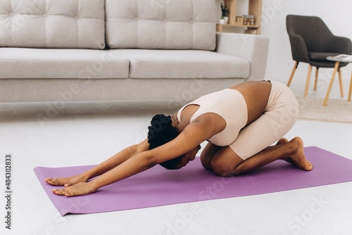 Domestic Workout. Young Sporty Black Woman Doing Plank Exercise At Home, Training In Living Room
