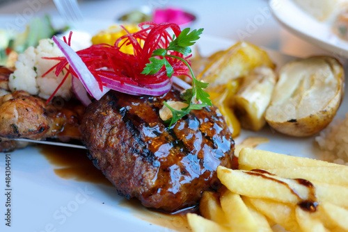 Steak with various garnish and sauce. photo