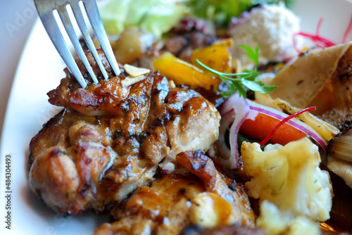 Steak with various garnish and sauce. photo