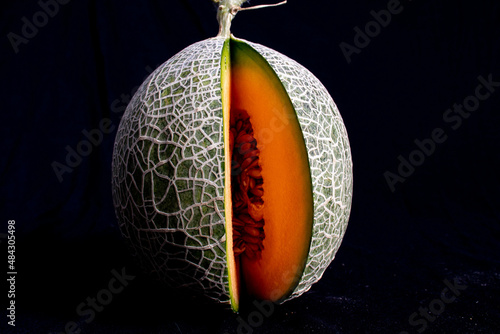 Photo of full organic melon from your own garden with a black background