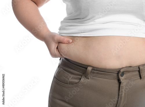 Overweight woman in tight shirt and trousers on white background, closeup © New Africa