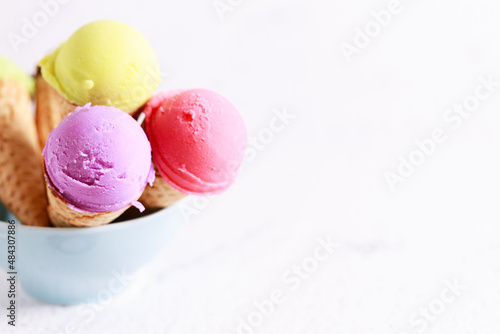 variety of ice cream scoops with waffle cones.