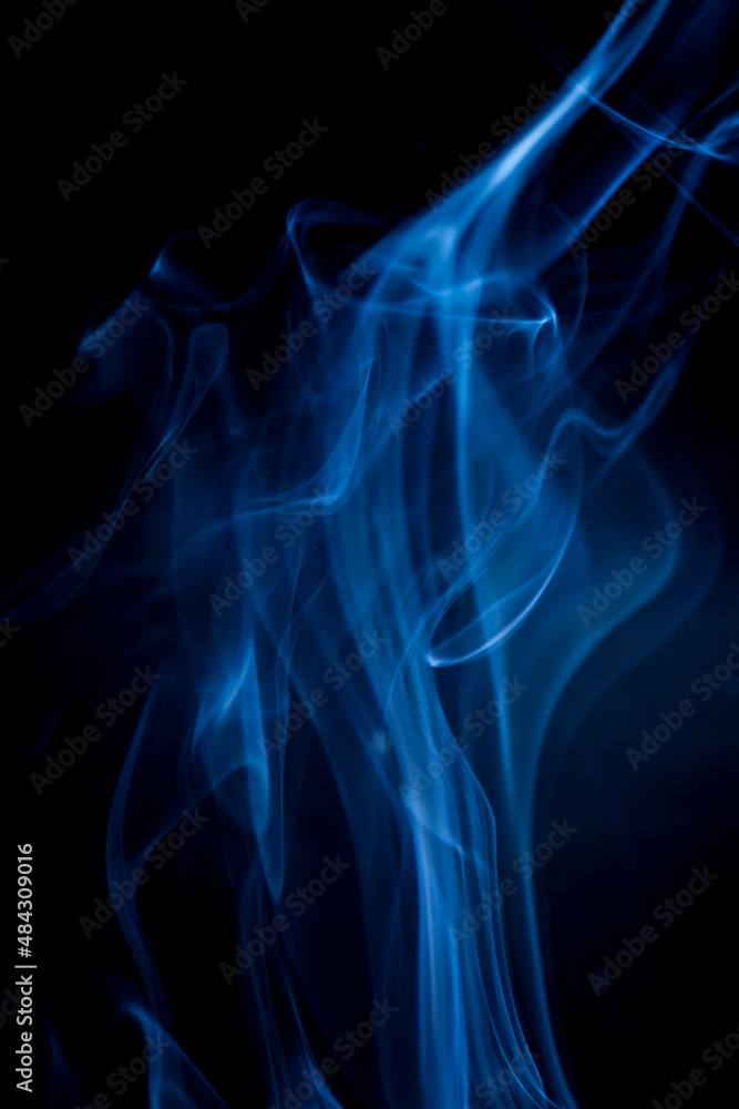 Fototapeta premium Blue smoke on black background.