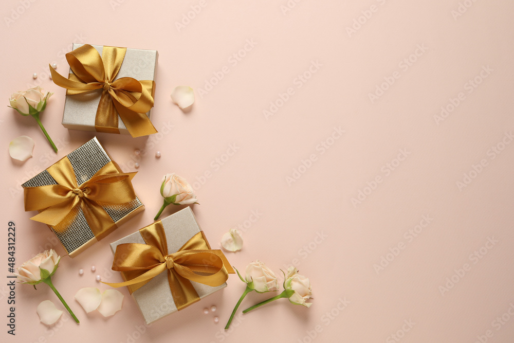 Beautiful gift boxes and flowers on pink background, flat lay. Space for text Beautiful gift boxes and flowers on pink background, flat lay. Space for text