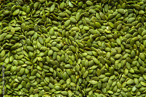 A closeup image of fresh healthy green pumpkin pepita seeds. photo
