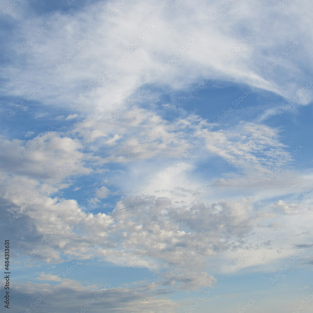 Fluttering clouds against a crystal blue sky
