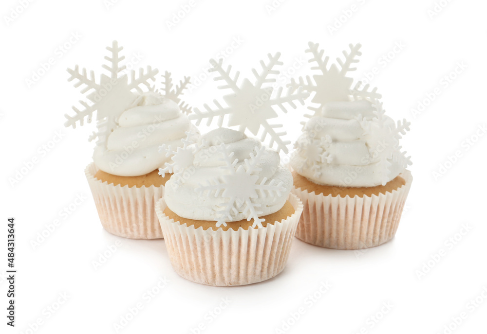 Tasty Christmas cupcakes with snowflakes on white background