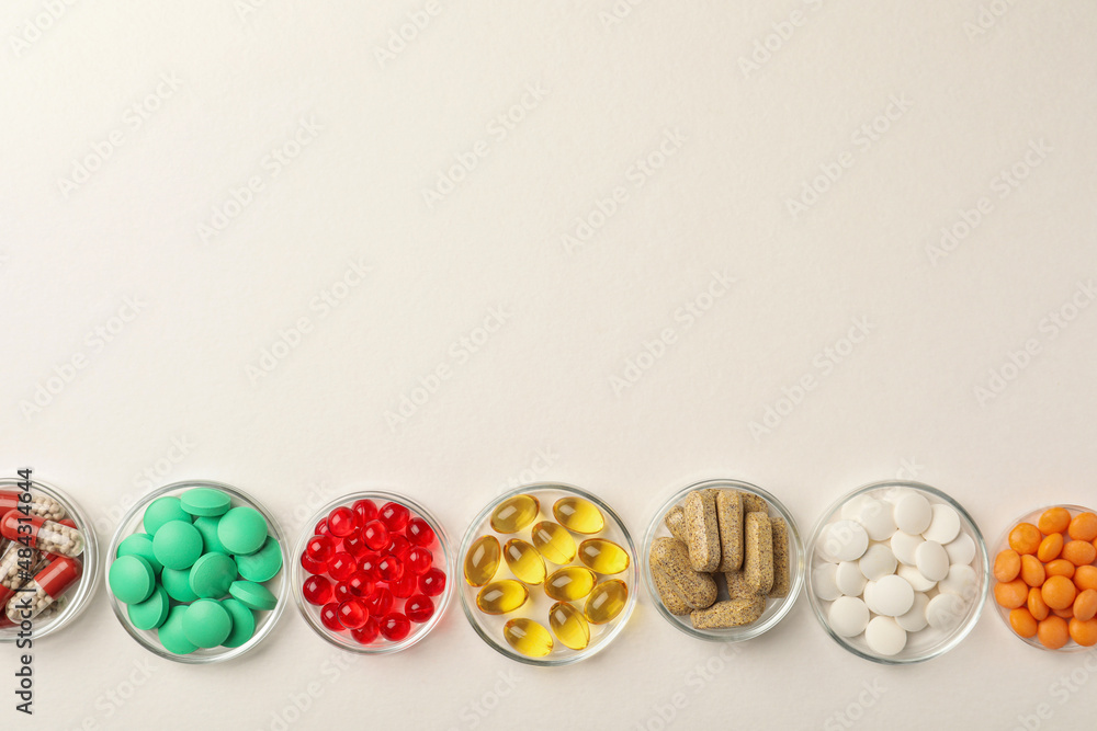 Different dietary supplements in bowls on white background, flat lay. Space for text Different dietary supplements in bowls on white background, flat lay. Space for text