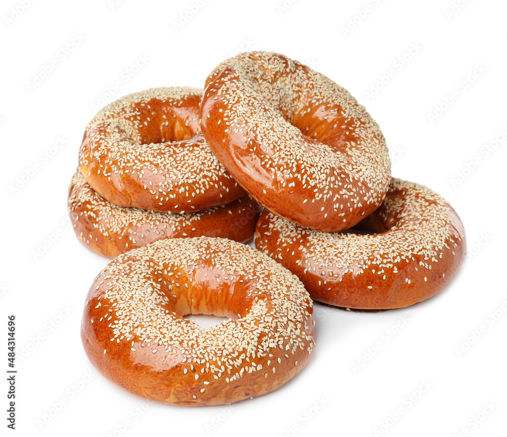 Many delicious fresh bagels on white background Many delicious fresh bagels on white background