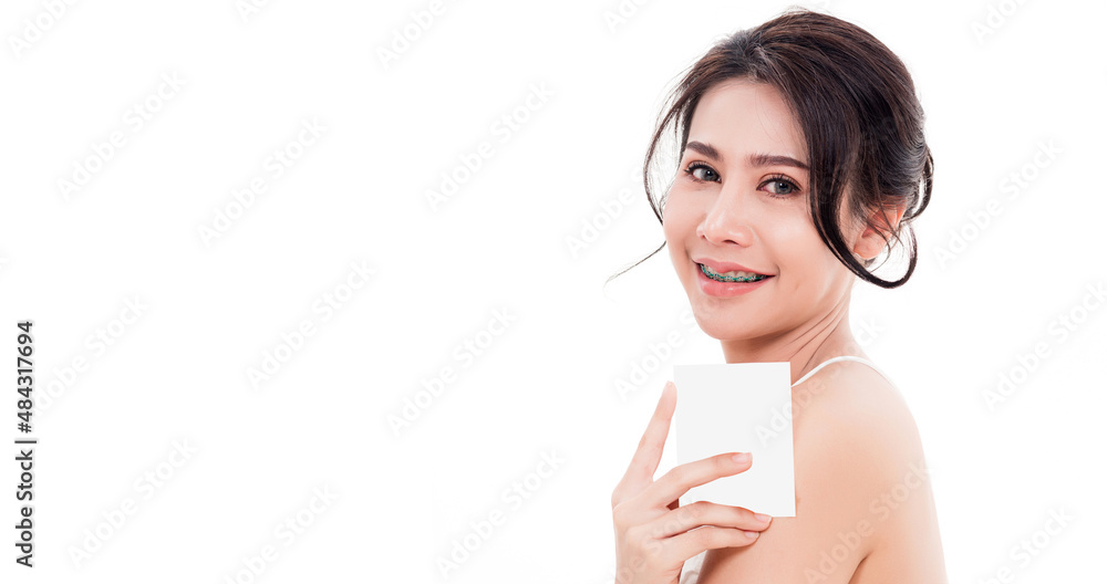 Asian young beautiful woman smiling she's holding blank square skin care near face for present product isolated on over white background, Beauty concept Asian young beautiful woman smiling she's holding blank square skin care near face for present product isolated on over white background, Beauty concept