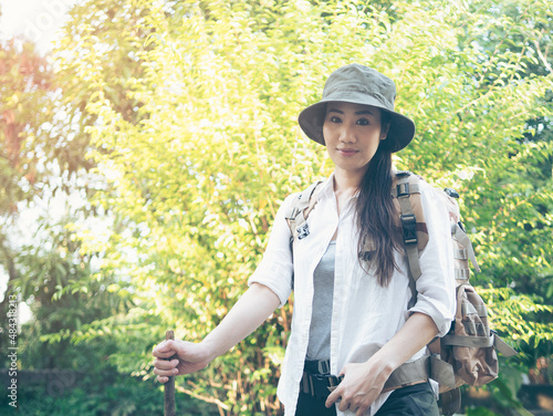 An Asian woman takes a vacation on a trekking trip to discover a new world.