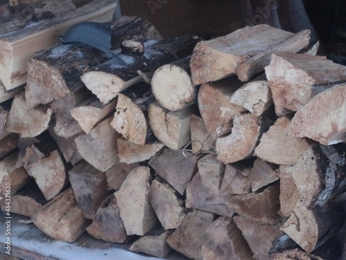 Dried logs stacked on the street photo