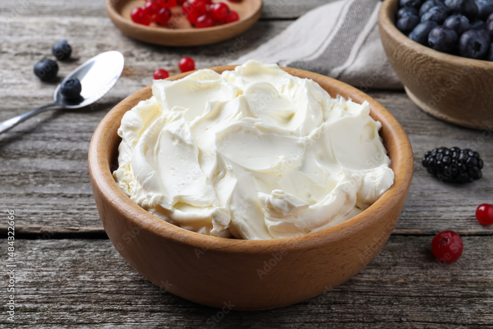 Tasty cream cheese and fresh berries on wooden table Tasty cream cheese and fresh berries on wooden table