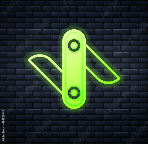 Glowing neon Swiss army knife icon isolated on brick wall background. Multi-tool, multipurpose penknife. Multifunctional tool. Vector