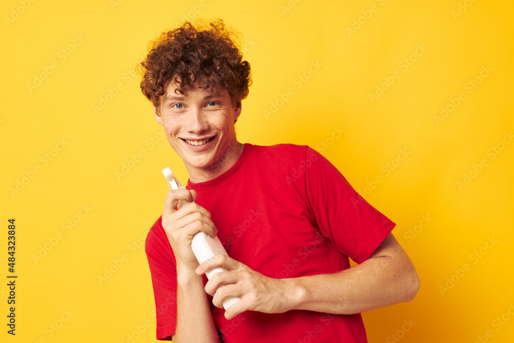 portrait of a young curly man detergent posing emotion yellow background unaltered portrait of a young curly man detergent posing emotion yellow background unaltered