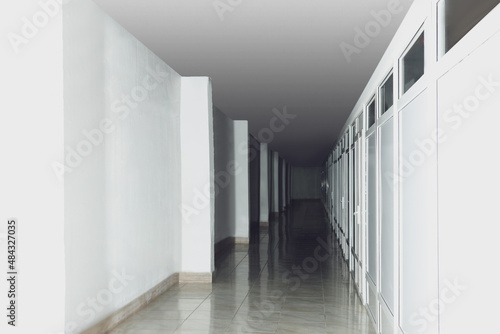 Modern empty office corridor with white walls