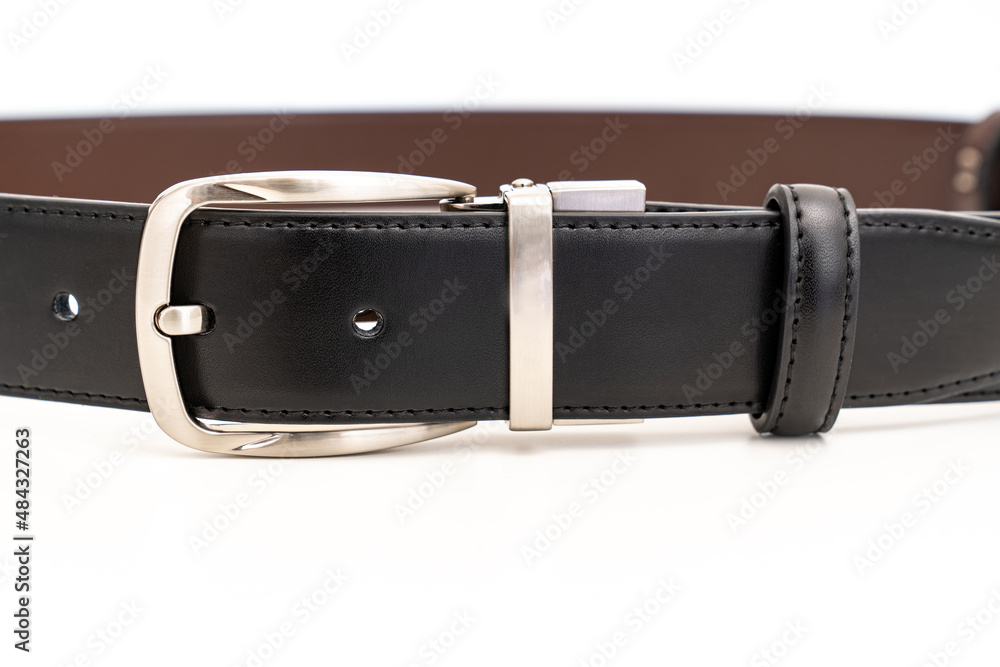 part of Double-sided black and brown leather belt on a white background. part of Double-sided black and brown leather belt on a white background.