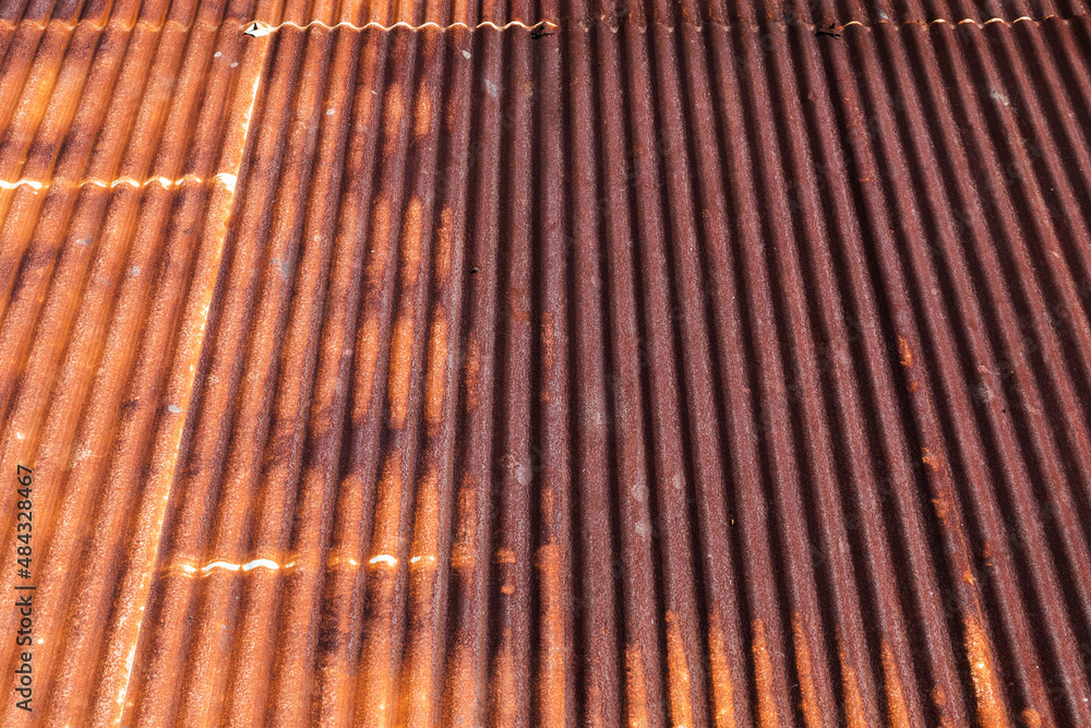 Fototapeta premium Background photo of a rusty red metal roof slope
