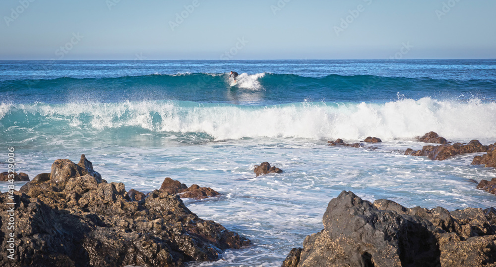 Lanzarote, Spain on Januari 3, 2022 - Surfer practicing his skills in the Atlantic ocean at Lanzarote