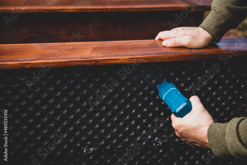 man tacking bubble wrap into the raised bed