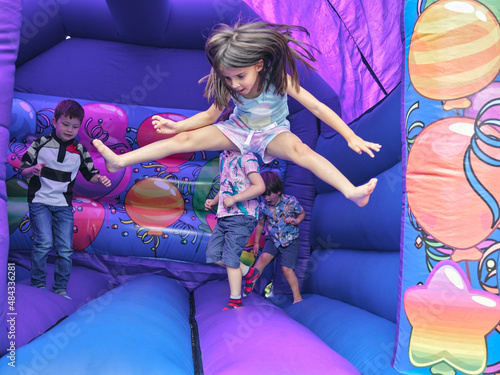 Children jumping in bouncy castle