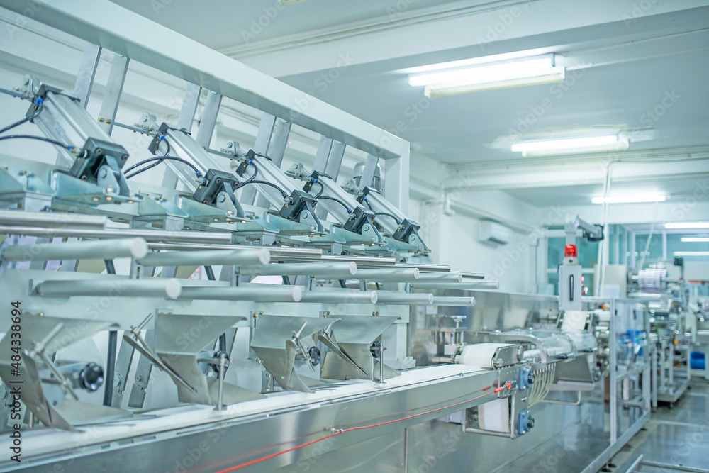 Fototapeta premium factory, industrial area, automation, technology, Machines for packing products Within the factory, sterile beauty industry in order to maintain maximum cleanliness.shallow focus effect. 