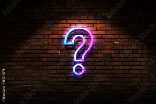 Question mark neon light design on brick wall