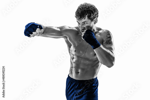 Studio shot of silhouette kickboxer who training practicing jab on white background. Blue sportswear © zamuruev