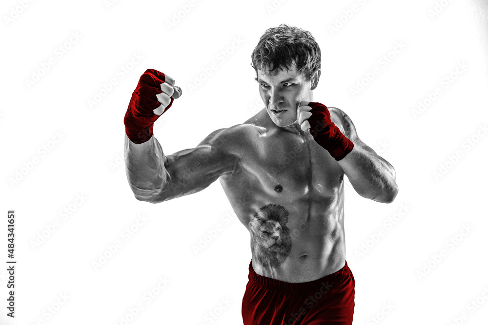Portrait of silhouette boxer who training, practicing uppercut on white background. Red sportswear