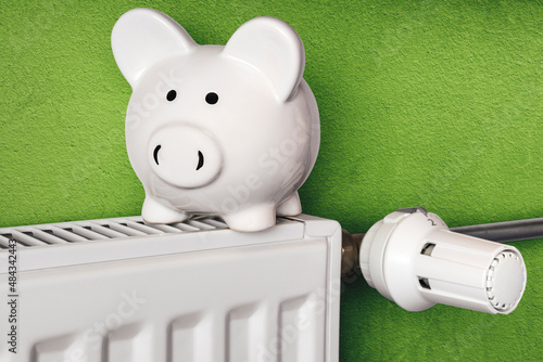 Piggy bank on radiator, increase of heating costs, save energy and money