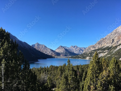Lake panorama among mountains in Italy. Blue Sky and green trees. © Lorenzo
