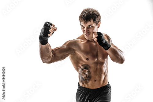 Studio shot of kickboxer who training, practicing uppercut on white background. Sport concept 