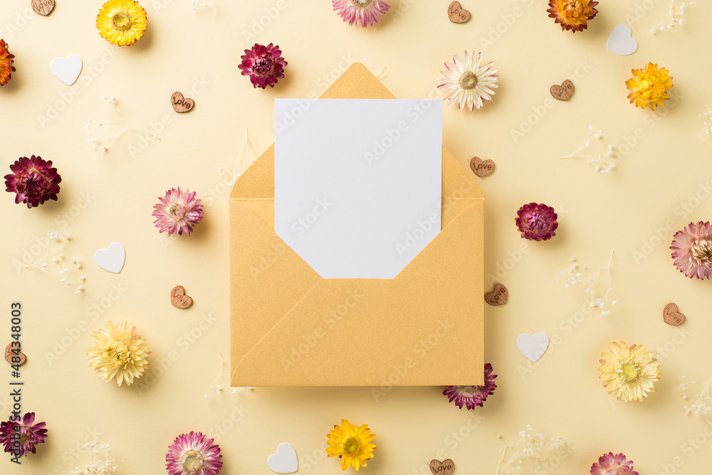 Top view photo of woman's day composition open pastel yellow envelope with letter different color field flowers and hearts on isolated beige background with blank space Top view photo of woman's day composition open pastel yellow envelope with letter different color field flowers and hearts on isolated beige background with blank space