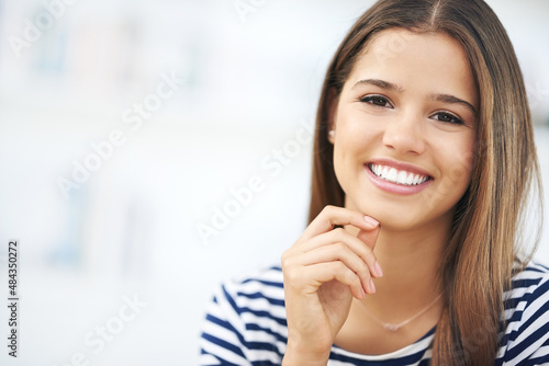 Her smile brightens up any room. Portrait of an attractive young woman relaxing at home. Free Download Her smile brightens up any room. Portrait of an attractive young woman relaxing at home. - GFXLoad