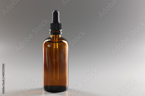 Closeup of glass brown jar with cosmetic serum photo