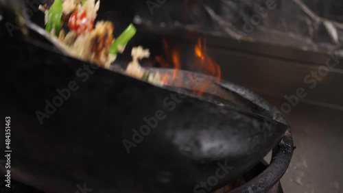 close up of moving wok with Thai fried rice