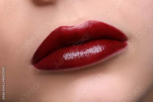 Closeup of beautiful female lips with red lipstick
