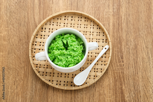 Tape Ketan Pandan is a typical Indonesian food made from fermented sticky rice. Served in small bowl. Selected focus. 
