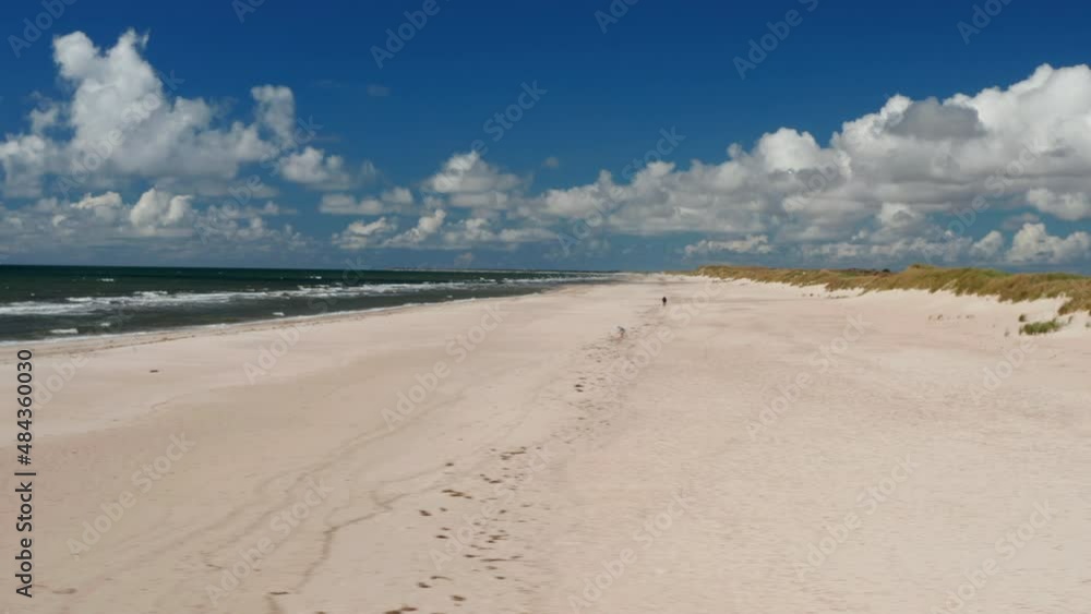 Slider of beautiful coastal landscape. Long white sand beach and waves washing coast. Summer vacation location. Denmark Slider of beautiful coastal landscape. Long white sand beach and waves washing coast. Summer vacation location. Denmark