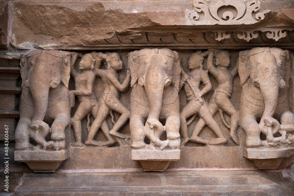 LAKSHMANA TEMPLE: Elephant and warrior on plinth.Western Group, Khajuraho, Madhya Pradesh, India