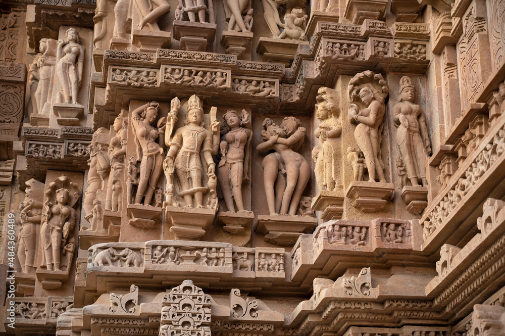 LAKSHMANA TEMPLE: Lord Chaturbhuj and erotic sculpture.Western Group, Khajuraho, Madhya Pradesh, India