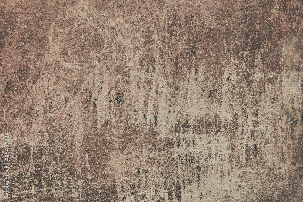 An old brown painted wall background. A plaster wall texture with rough scratches. An old brown painted wall background. A plaster wall texture with rough scratches.