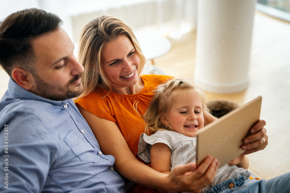 Happy family spending time at home with digital devices together. Technology people fun concept. Happy family spending time at home with digital devices together. Technology people fun concept.
