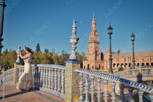 Flamenco dancer, woman, brunette and beautiful typical spanish dancer is dancing and clapping her hands in a square in seville. Flamenco concept of cultural heritage of humanity.